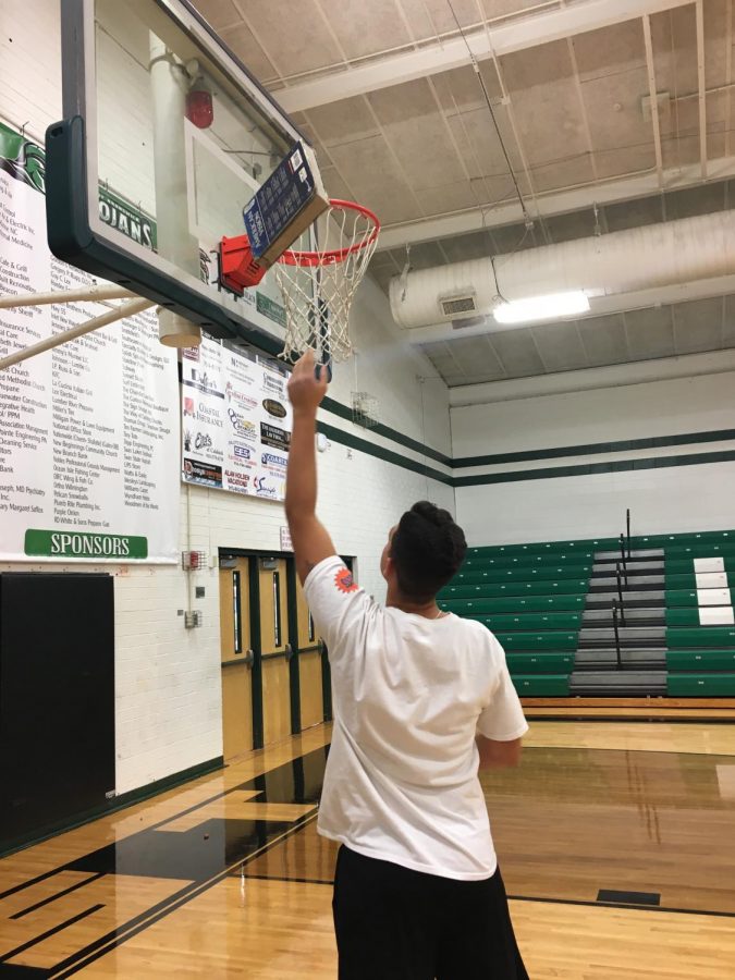 Athlete Gianni Donatelli shows the struggle between balancing basketball and classes.