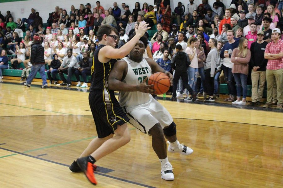Javian McCray pushes past topsail defender to make a layup
