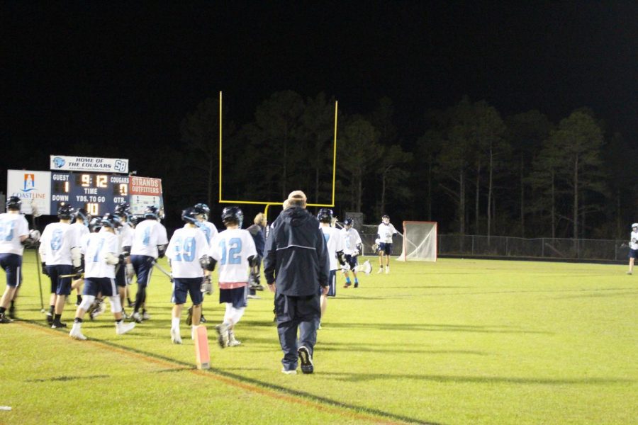 SBHS Cougars rush the field to grab their goalie, Rory Gannon at halftime.
