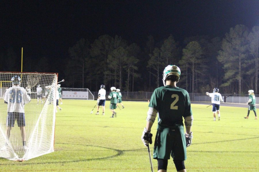 William McRainey stands behind the goal on attack as the ball is moved down the field. 