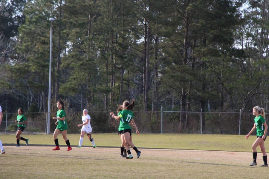 Seniors Jes Barbra and Greer Jocelyn celebrating after the first goal of the game.