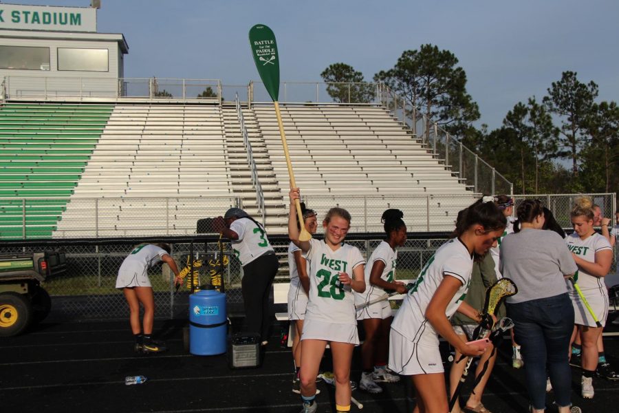 Kara "KB" Cheers holds up the teams Brunswick County Championship 'trophy' following their win over SBHS.