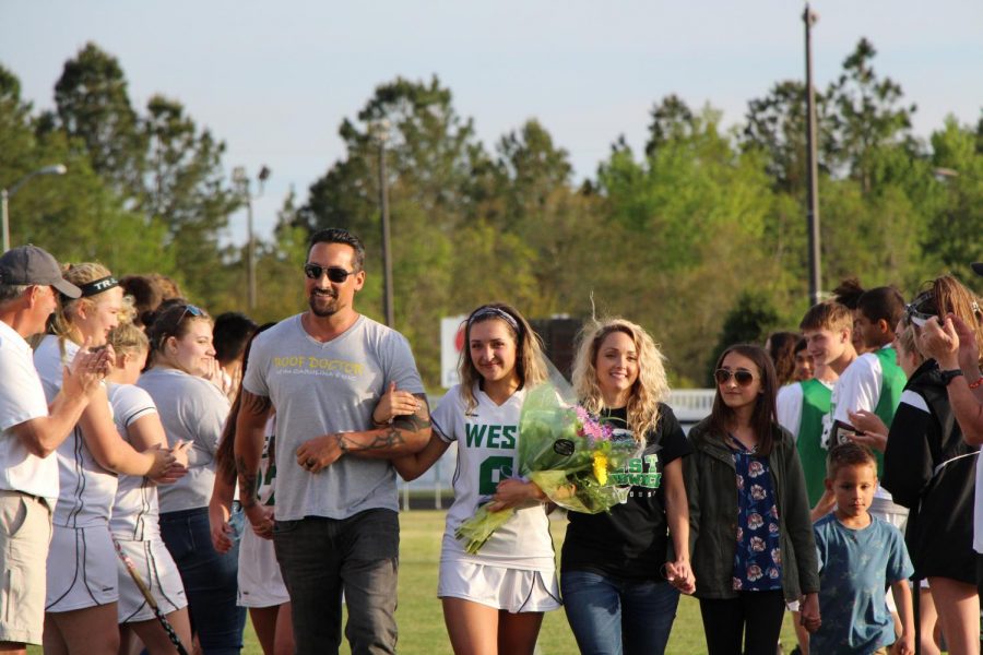 Attacker Chloe Lach walks through the tunnel with her family.