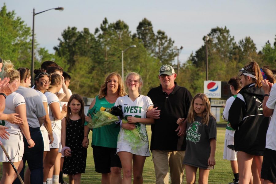 Attacker and captain Kara "KB" Cheers cries as she walks through the tunnel with her mother, father, and two younger sisters.