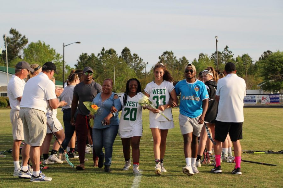 Defender and captain Kaliyah Matthews walks through the tunnel with her mother, older brothers, and best friend, Cecelia Vergara. 