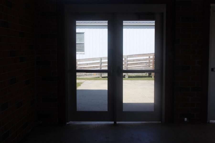 A capture of the locked doors to an entrance to a school.