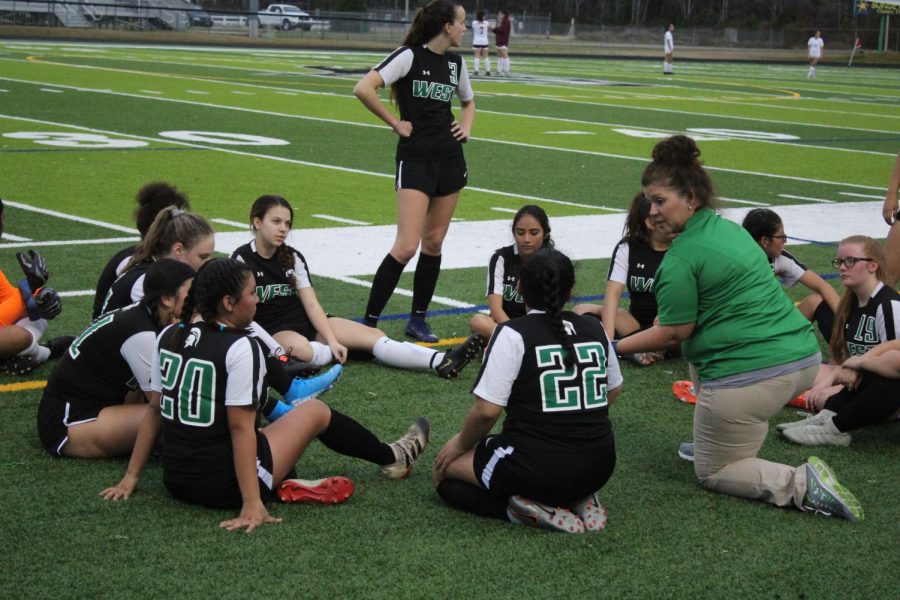 Coach Leonard gives the team a pep talk during half time