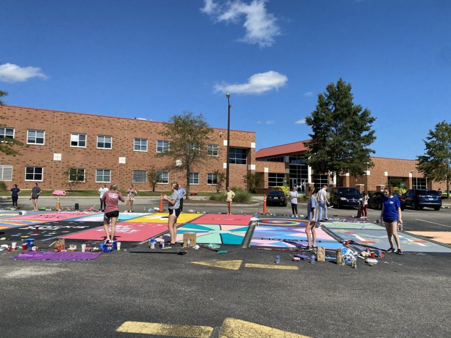Everyone works hard on painting their parking spot.