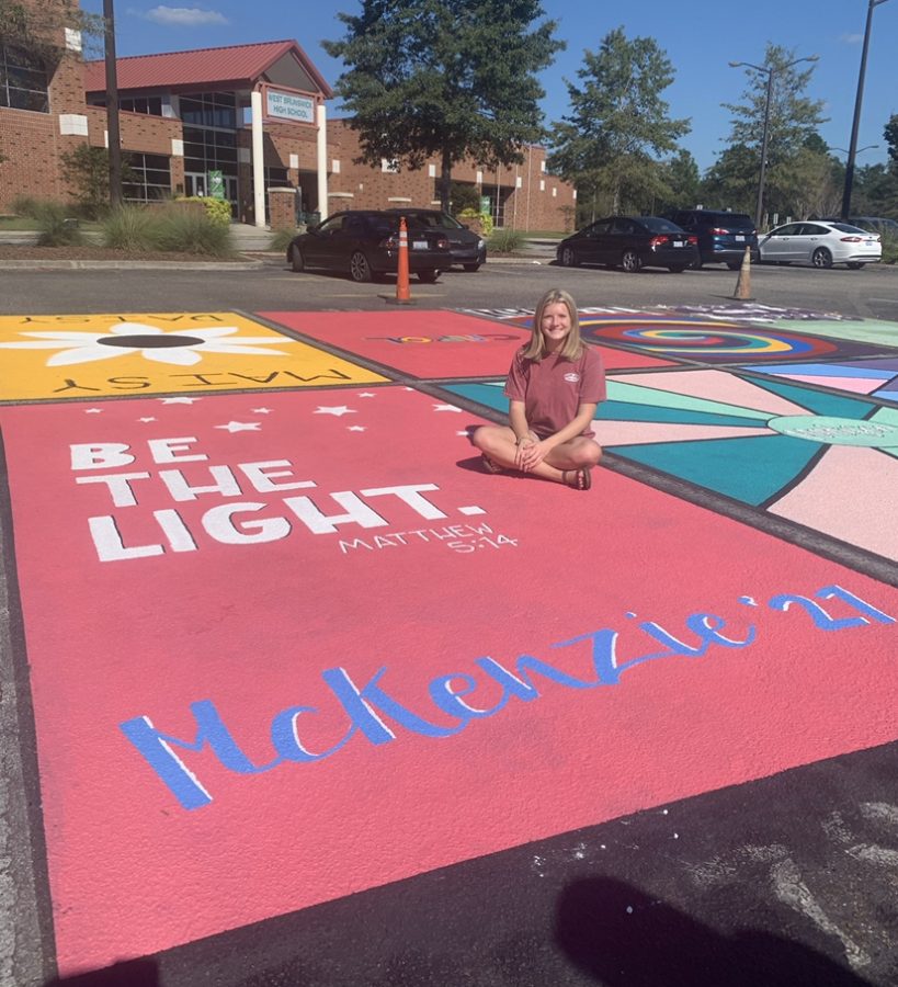 Senior Mckenzie Pope finishes up her parking spot.