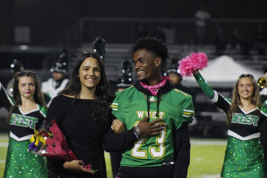 Kyla Bryant and Tayveon King smiling during homecoming announcements 