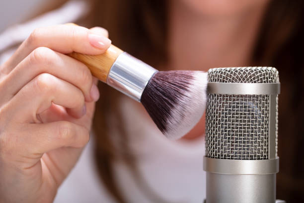 Woman using brush on microphone to make ASMR sounds