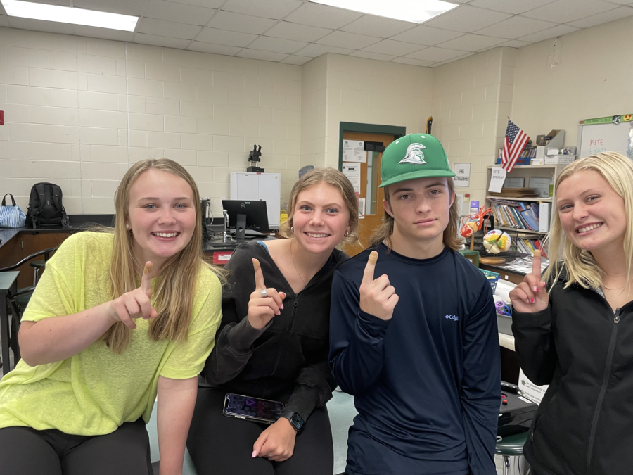 Addi Hardee, Camdyn Beck, Tanner Fields, and Macy Sellers holding up their bandaged fingers after finding out their blood type