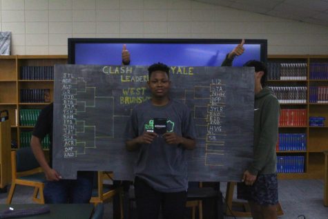 The winner stand infront of the bracket board with his 1st place prize