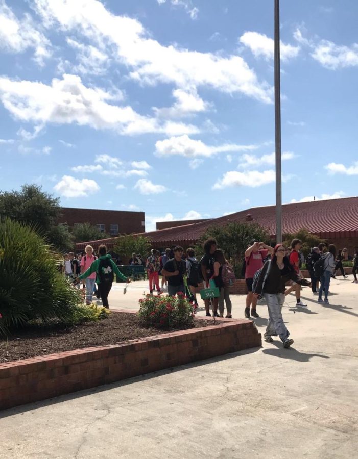 Crowds walking through the courtyard making their way to the front of the school. 

Photo credit: Jenna Williams