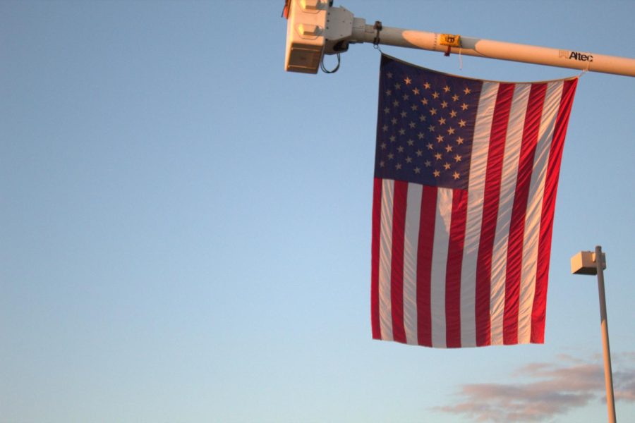The American Flag hangs from a linemans truck, a symbol of freedom
