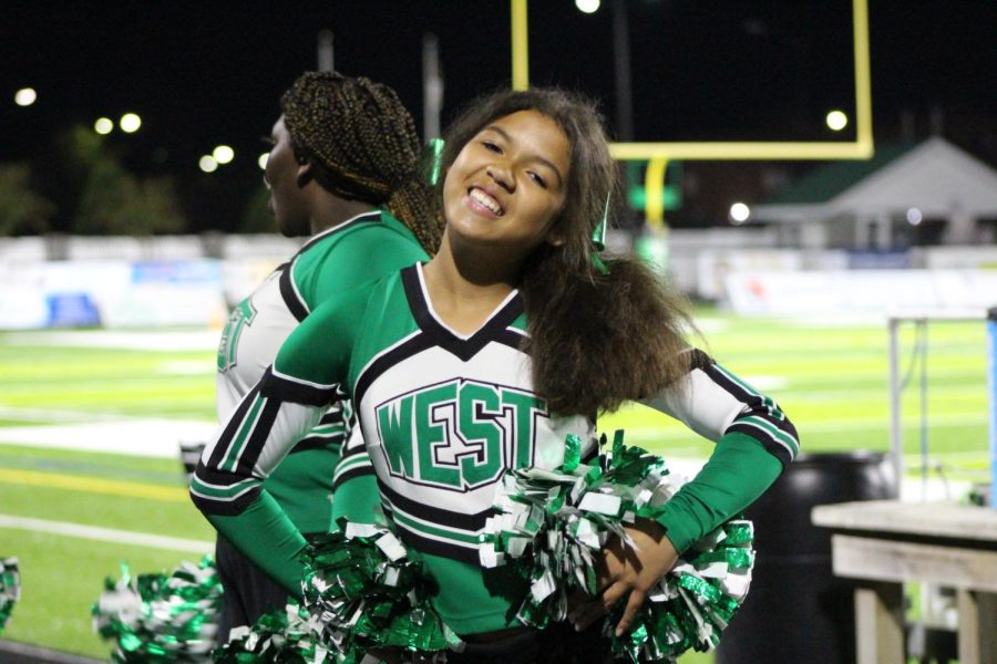 JV cheerleader Jazmine Roberts poses for a picture on the sidelines.