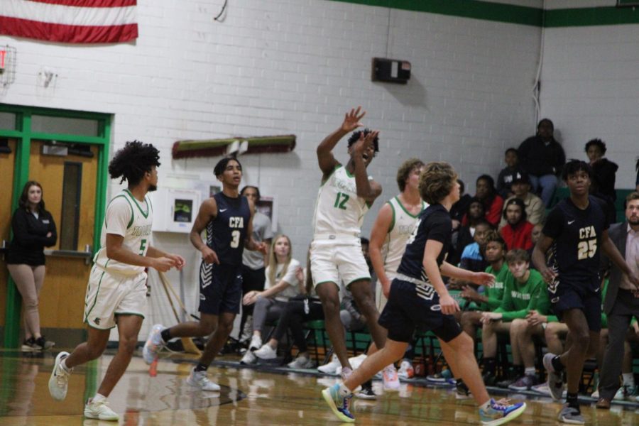Senior Kevon Daniels throws the ball up the court in a buzzer-beater attempt. 