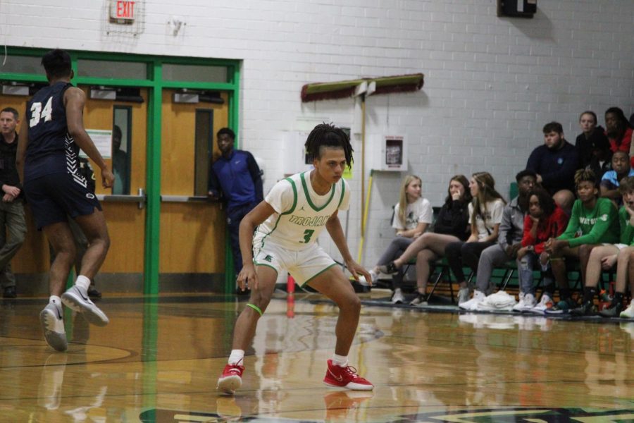 Senior Cylil Lee prepares to defend the CFA basketball players. 
