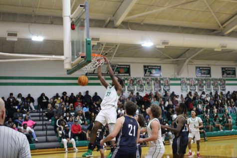 Senior Quincy Hankins dunking the ball to score two points for his team. 