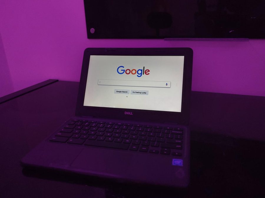 A black Google Chromebook displaying the Google Chrome search bar.