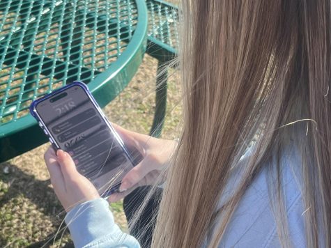 Junior Kearstin Herring looking at all of the social media notifications on her cell phone.