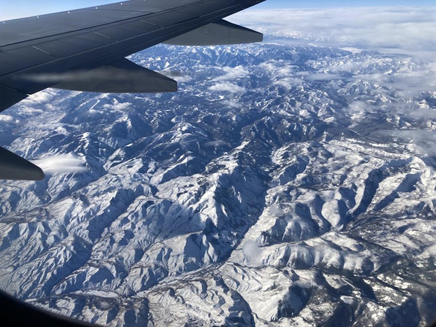 Picture of mountain Range with Wing of Airplane in Shot
