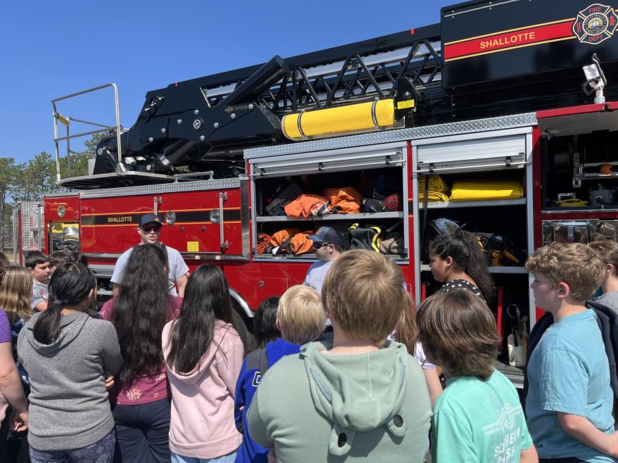 Shallotte firemen talking to students from Union Elementary, while answering their questions.