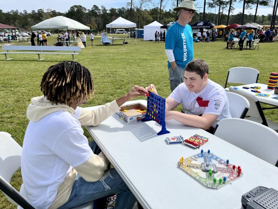 Junior Kaden Bryant playing Connect 4 with Jason Radford after finishing their events.