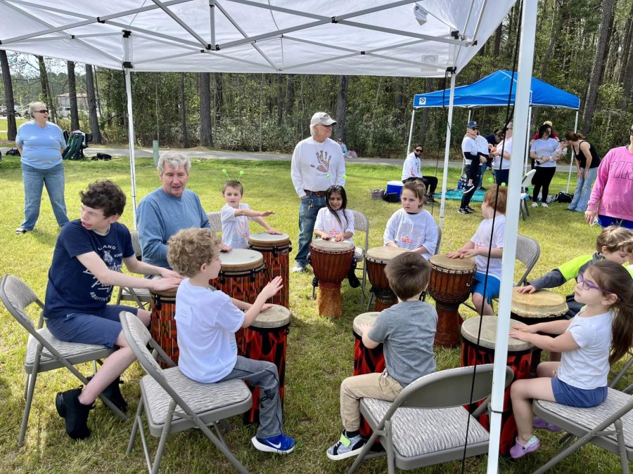 Town Creek Elementary students being taught how to play the bongo drums. 