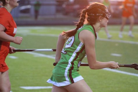 Senior Lauren Nelson, running down the field.