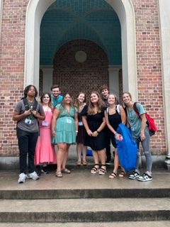 West Wind staff poses in front of the Bell Tower after the awards luncheon.