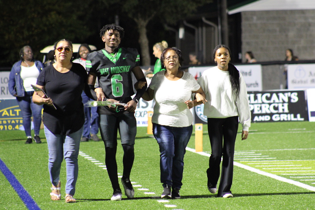 Tyreick Woodard walking with his family. 