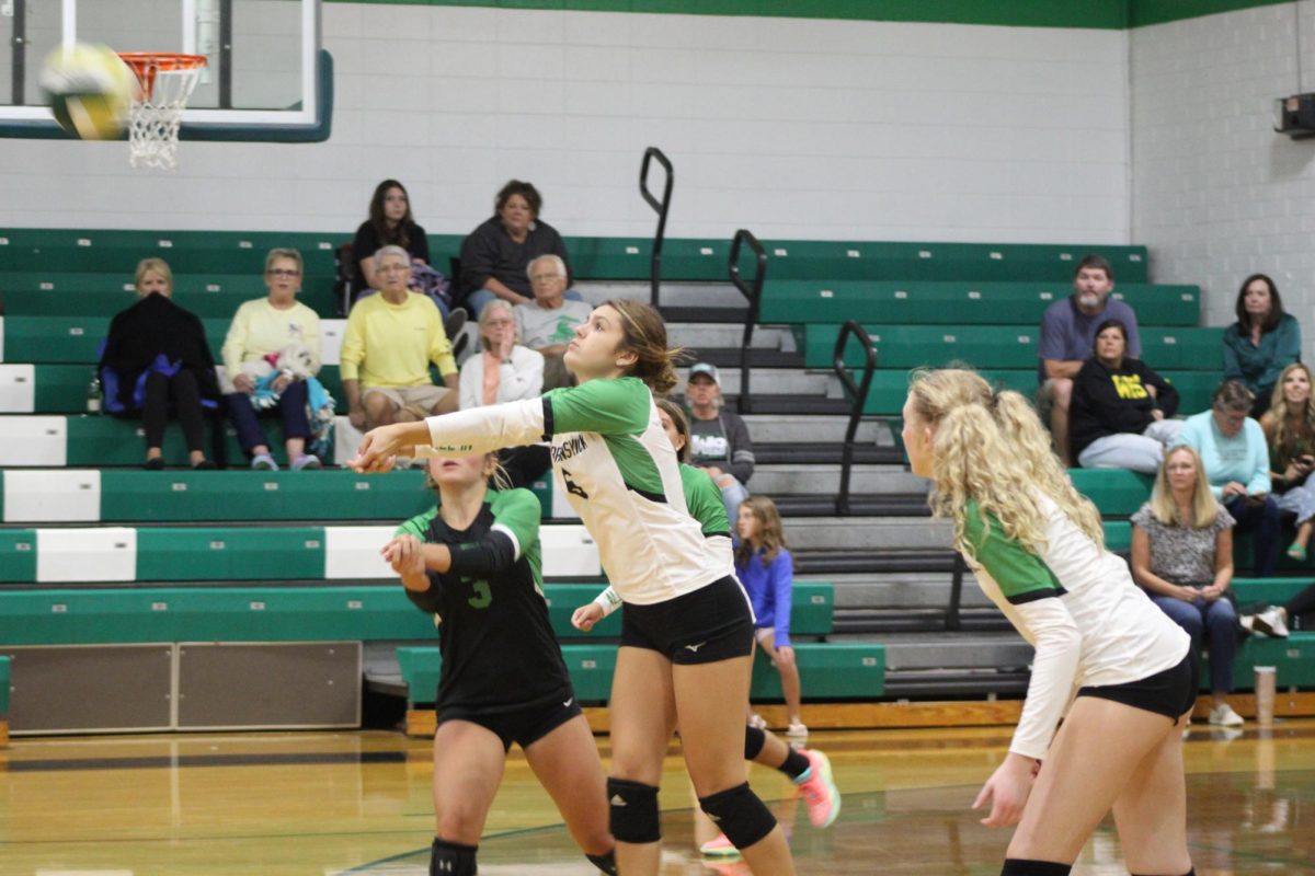 Senior Emma Bartlett hits the ball to the opposing team. Bartlett was prepared for this as she set herself up for the hit. 