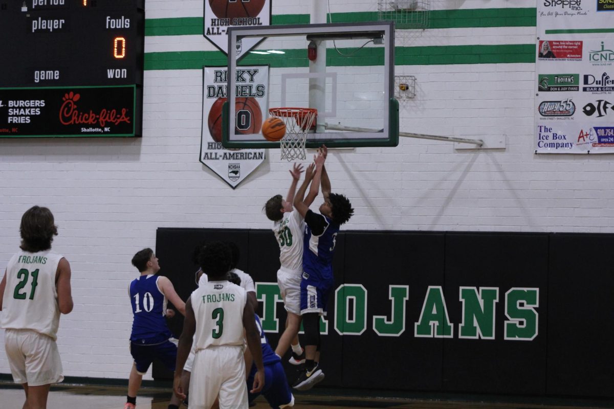  Sophmore Caden Mcmillan going up to make a shot while the other team trys to block it 