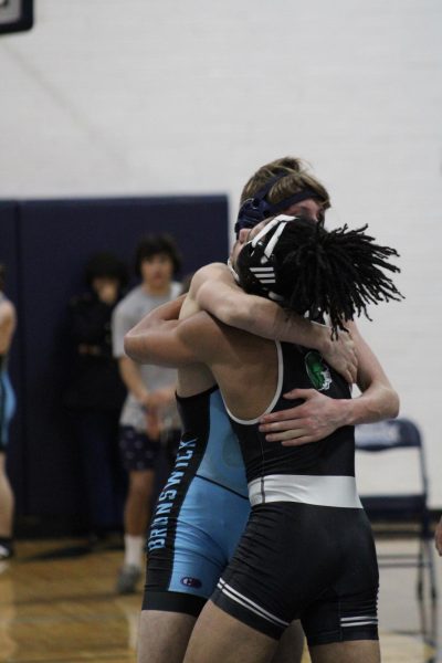 Senior Austin Hill and brother hugging after their match against each other. 