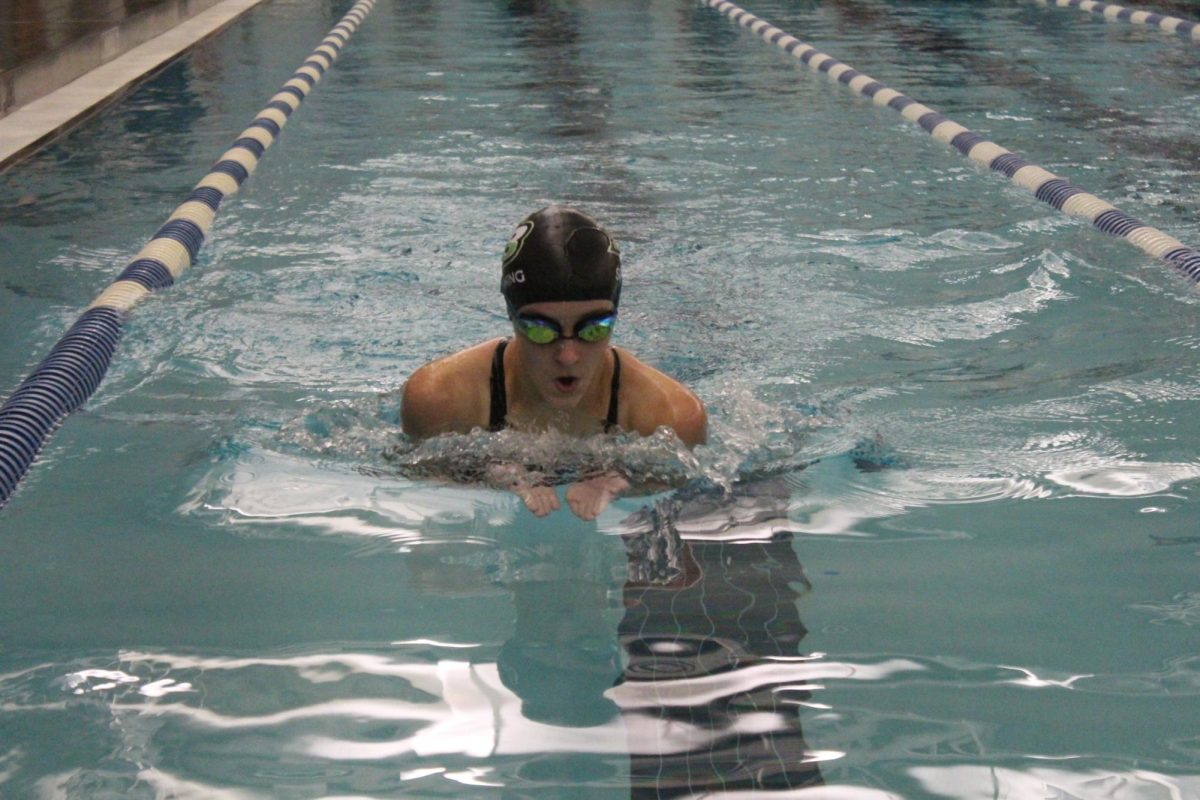 A swimmer breaking through the water as they try to take the lead.