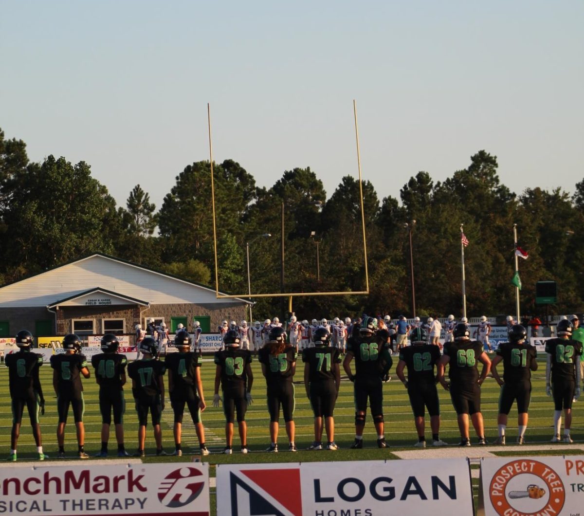 Team lined up ready to play. They wait for the national anthem to start and begin. The adrenaline is high.