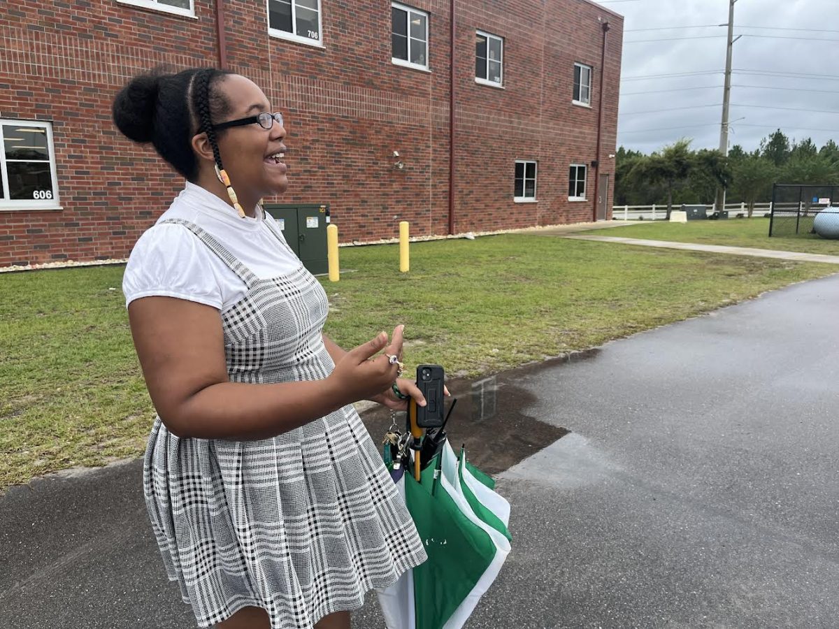 Assistant principal Karla Stanley  monitoring students getting on the bus.