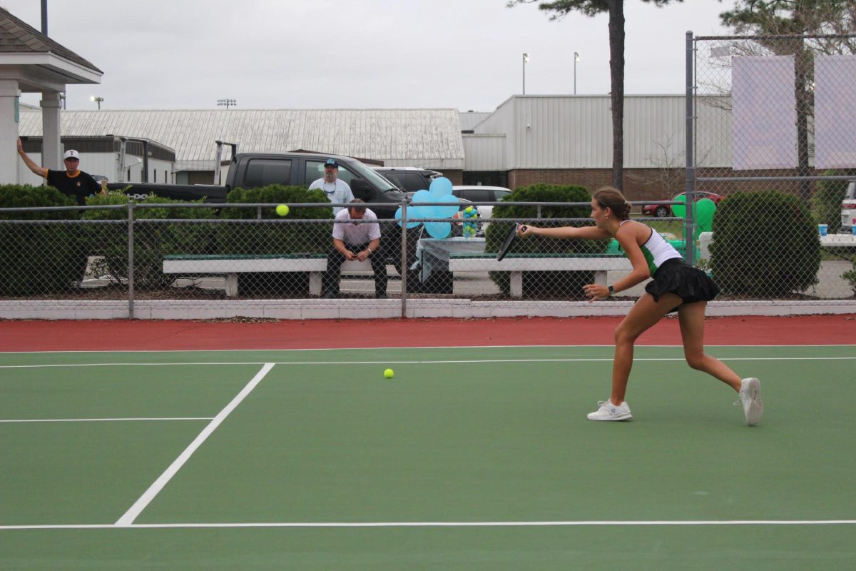 Senior Hannah Cumbee using a forehand to get the ball over the net. 