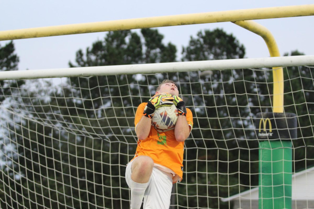 Brayden Griffith practicing trapping the ball as the goalie on the team.