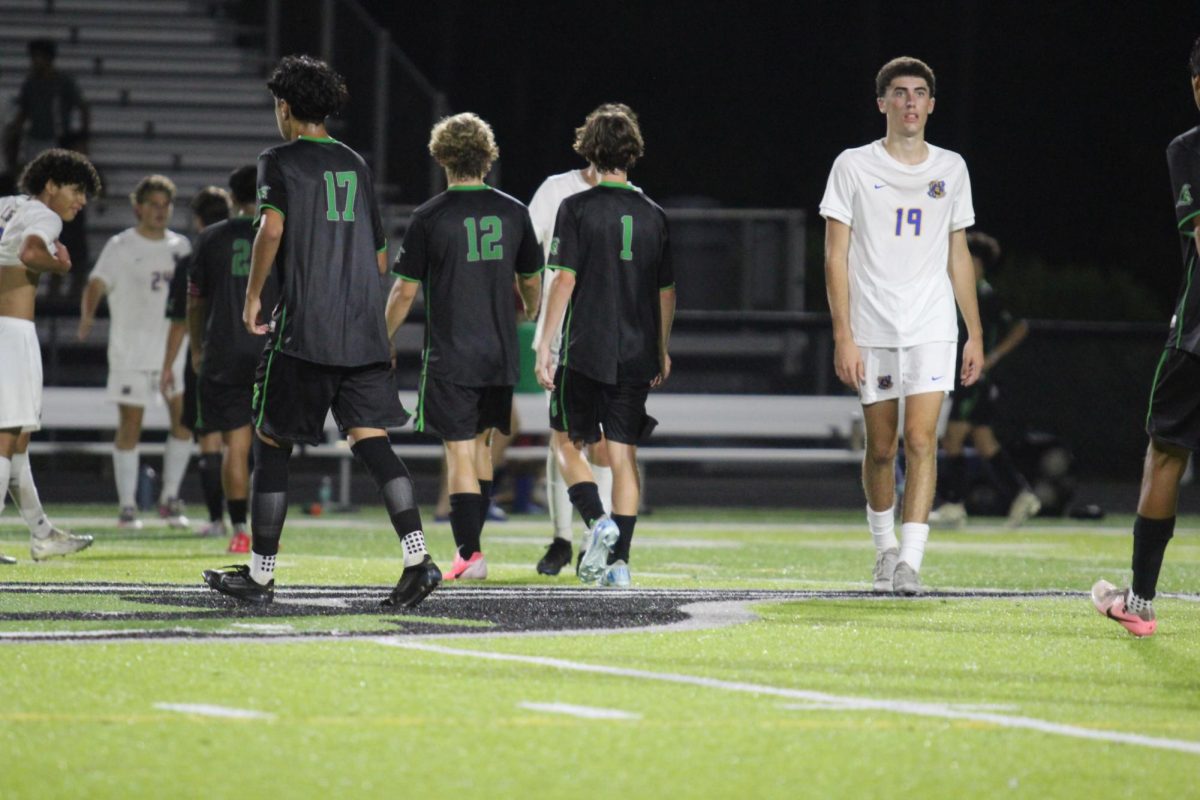 Henry Phillips, Garrett Granade and Melvin Bausita walking together after the game ends.