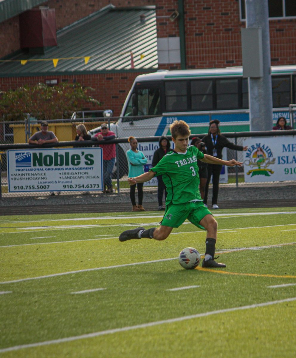 Sophomore Parker Clark taking a free kick in hopes to move the ball back up the field. 