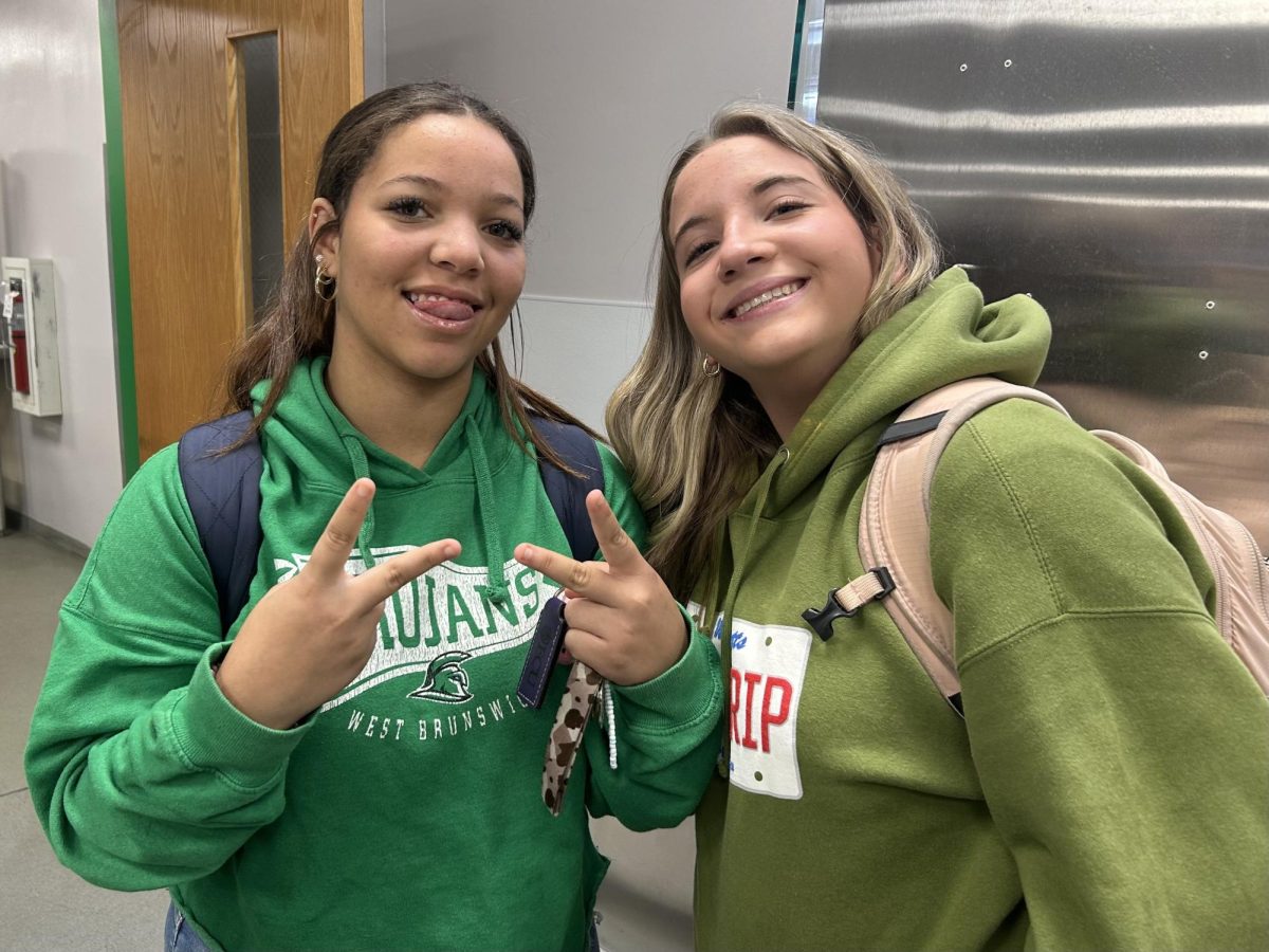 Sophomores Marianna Simpson and Claire Webster pause breakfast to show off their green. 