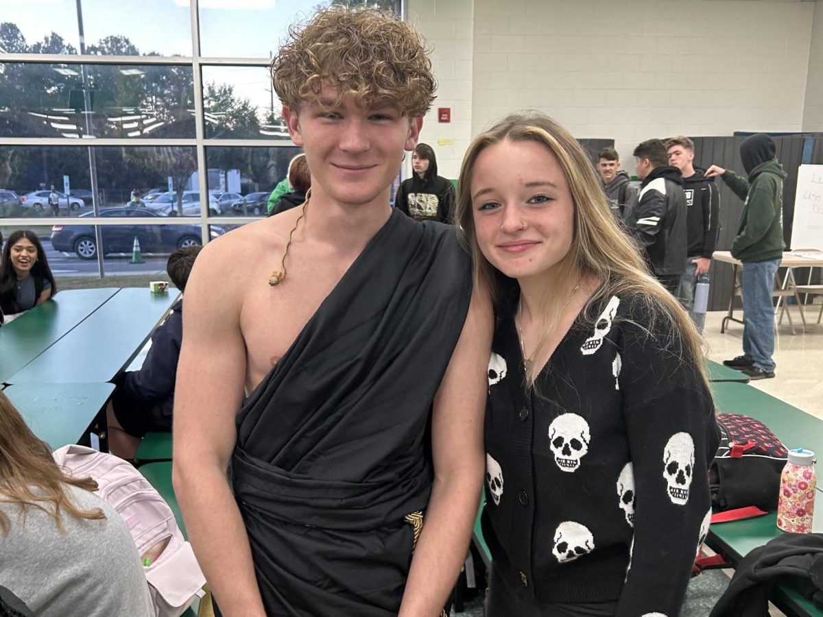 Senior Bladen Jayne and junior Kaitlyn Tysinger huddle for a quick photo during breakfast, rocking their respective colors. 