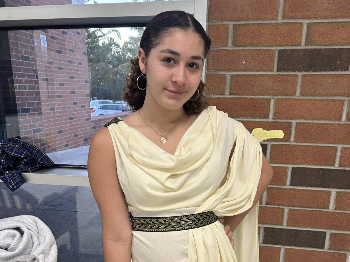 Senior Keanna Whitt smiles in her fresh toga early in the school day. 