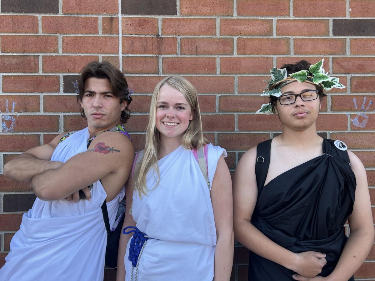 Seniors Jacob Rumsey, Teagan Blake Julius Rogers and strike a pose outside to show off their togas. 