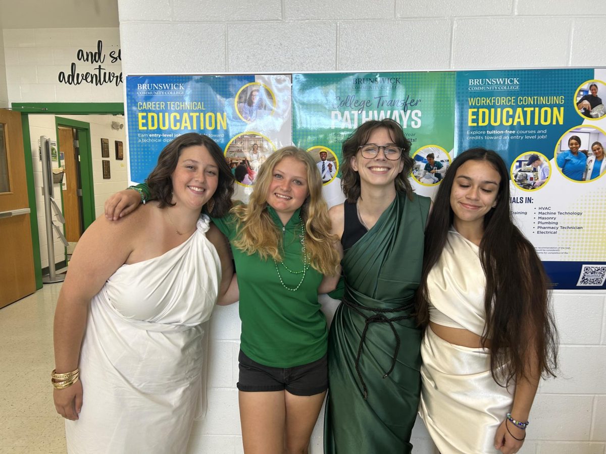 Seniors Hannah Underwood, Eve Feldman and Brianna stand with sophomore Kimberly Bart on their way to lunch.