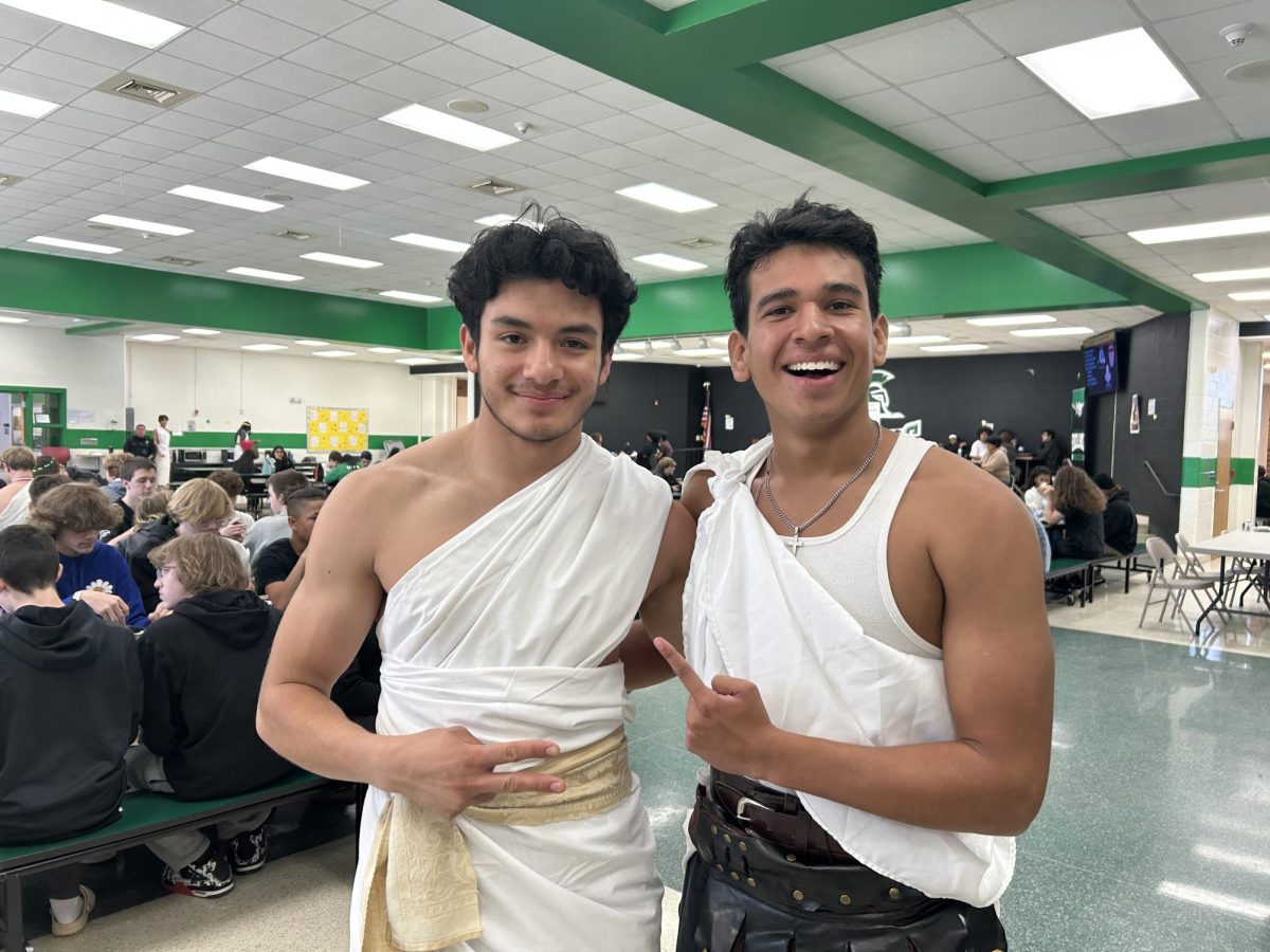 Seniors Osmon Solis and Julian Linares cheese for the camera in their togas during lunch. 