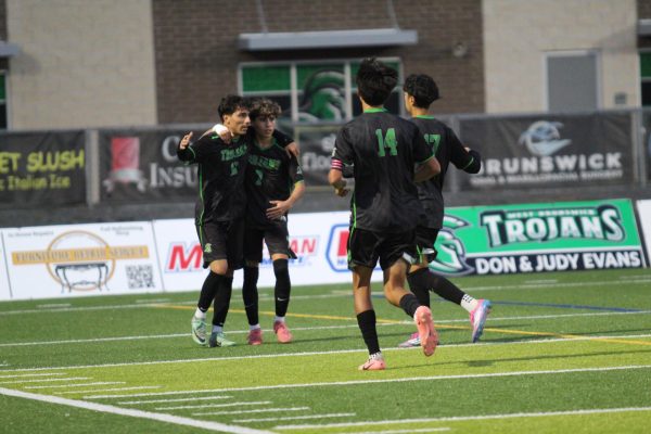 West team members celebrating after a goal.