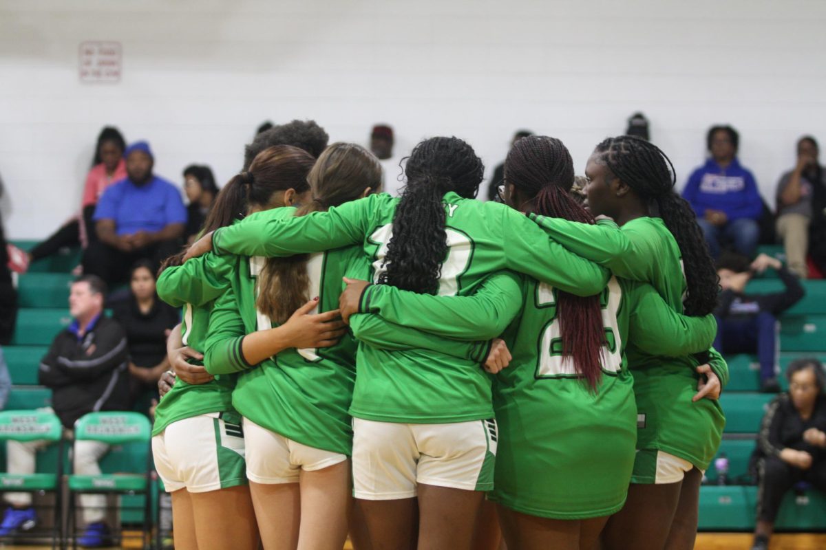 The Varsity girls having a pep talk after finishing their warm up before starting the game.